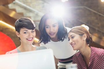 Businesswomen using laptop in office
