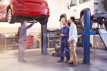 Mechanic talking to customer in auto repair shop