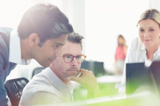 Business People Working At Computer In Sunny Office