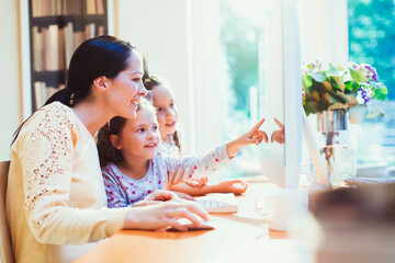 Mother and daughters using computer