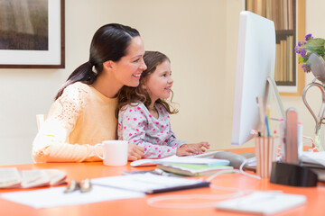 Mother and daughter using computer