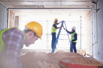 Construction worker on ladder at construction site