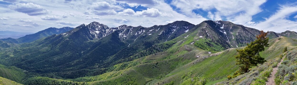 Rocky Mountain Wasatch Front peaks, panorama landscape view from Butterfield Canyon Oquirrh range toward Provo, Tooele Utah Lake by Rio Tinto Bingham Copper Mine, Great Salt Lake Valley in spring. Uta