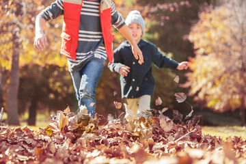 Boys running in autumn leaves © Tom Merton/KOTO