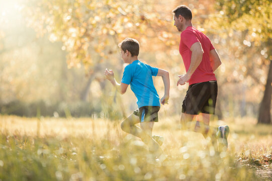 Father and son jogging in park