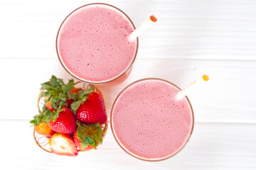 Strawberry yogurt fruit juice smoothie pink colorful fruit juice milkshake blend beverage healthy high protein the taste yummy In glass drink episode morning on white wood background from the top view