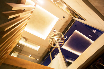 Illuminated tray ceiling and modern pendant light hanging in luxury foyer
