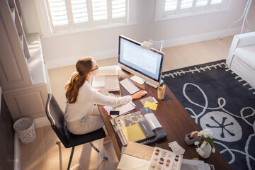 Interior designer working at computer in home office