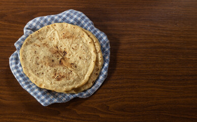 Corn tortilla on checkered tablecloth, delicious Latin American vegan food