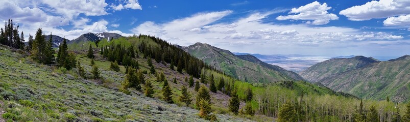 Rocky Mountain Wasatch Front peaks, panorama landscape view from Butterfield Canyon Oquirrh range toward Provo, Tooele Utah Lake by Rio Tinto Bingham Copper Mine, Great Salt Lake Valley in spring. Uta
