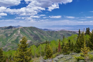 Obraz premium Rocky Mountain Wasatch Front peaks, panorama landscape view from Butterfield Canyon Oquirrh range toward Provo, Tooele Utah Lake by Rio Tinto Bingham Copper Mine, Great Salt Lake Valley in spring. Uta