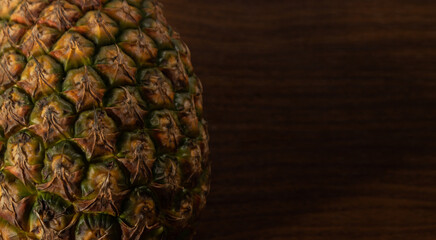 Ripe pineapple with rustic wooden background with space for text