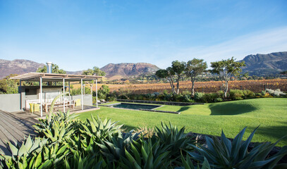 Sunny modern patio and yard with mountains in background