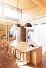 Modern pendant lights hanging over wooden kitchen island