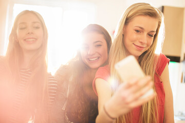 Teenage girls taking selfie with camera phone