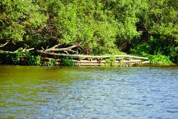 Fototapeta na wymiar Unused Bamboo boat kept in a riverside of Kuruwaisland,Wayanad