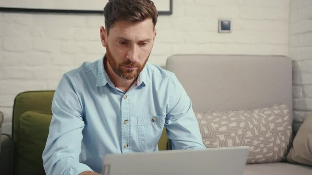 Close up upset businessman getting bad news on laptop at home internet remote technology online frustrated computer screen work caucasian slow motion