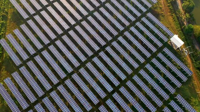 4K aerial shot of solar panels. Blue solar panels. photovoltaic modules for renewable energy.