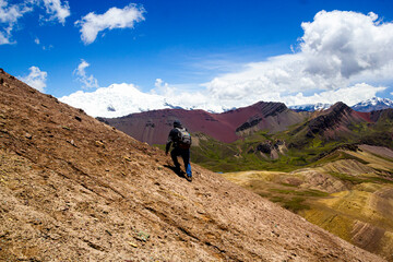 climbing to the colorful mountain of Peru, with snowy in the back, vinicunca rainbow mountain