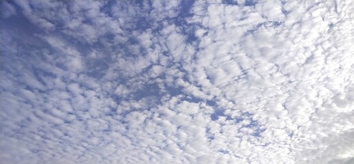 The morning sky, white clouds alternating with natural waves, obscures the blue background from Thailand.