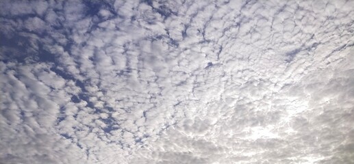 The morning sky, white clouds alternating with natural waves, obscures the blue background from Thailand.