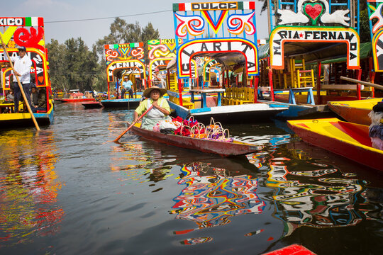 Mexican workers painting colorful trajineras boats in xochimilco, Mexico City, Mexico. 2016-12-19