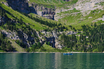 Father and son row a boat in the Swiss alps