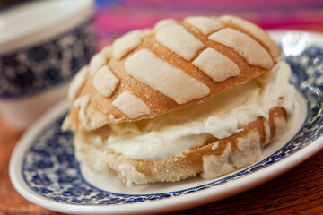 Traditional mexican breakfast known as pan con nata (bread with cream)
