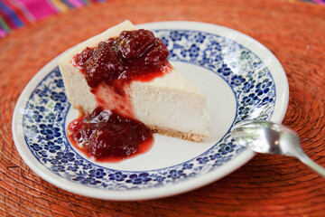 cheesecake with berries served in a mexican style plate