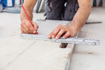 Der Fliesenleger arbeitet im Badezimmer eines modernen Hauses.