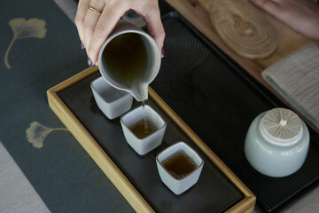 Chinese Tea Ceremony experience. Exquisite hot tea at traditional Chinese Tea Ceremony.  Caucasian...