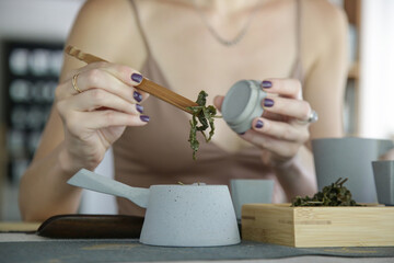 Chinese Tea Ceremony experience. Exquisite hot tea at traditional Chinese Tea Ceremony.  Caucasian woman participating in a traditional tea ceremony class. 