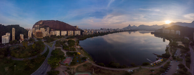 Aerial view of traffic crossroad and recreational park at the Lagoa Rodrigo de Freitas city lake in Rio de Janeiro with the Two Brothers mountain in the background