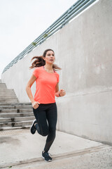 Portrait of fitness woman running.