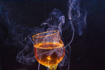 glass cup with drink and smoke