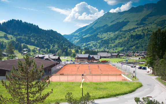 Clay tennis courts in a picturesque Les Diablerets in Switzerland. Most Beautiful tennis courts in the world.   