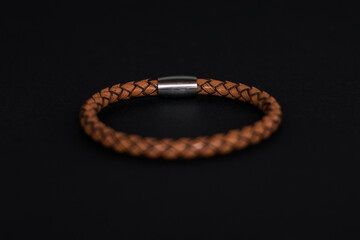Men leather clear brown bracelet on black background