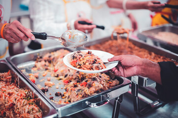 Naklejka premium Homeless and needy people receive help, receive food from volunteers : concept of food donation