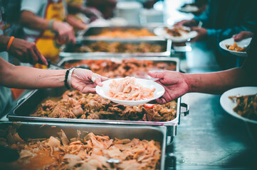 The donor gives food to the poor in Asian society : concept of sharing food to the poor