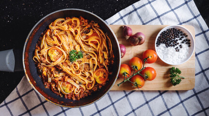 Pasta Bolognese tomatoes sauce with fresh ingredient on wooden tray