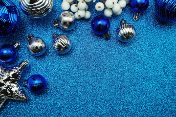 Christmas balls decoration ornaments with space copy on blue glitter background