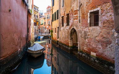 Picturesque landscape. Historic city center a narrow canal, old colorful buildings. Venice, Italy.