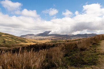 Distant view of Mount Aso volcano releasing steam days before eruption (November 2019). Kyushu, Japan.