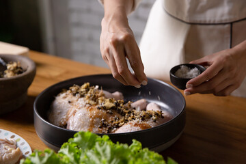 The chef cooks marinated chicken in his kitchen.