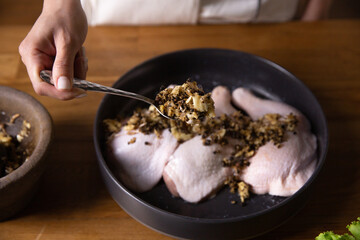 The chef cooks marinated chicken in his kitchen.