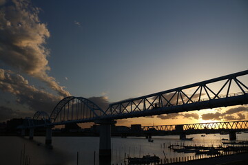 railroad bridge over the river in the evening