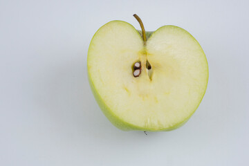 Red and green apple, half apple, bitten apple on a white background, seeds