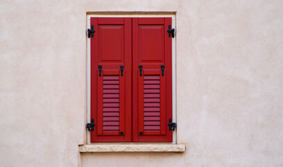 Old building in italian village. Stone wall with windows and shutters. Building with beautiful old architecture. Old window on old wall. Architecture and landmark.