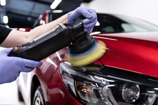 Man Worker Of Car Detailing Studio Polishing Car Varnish