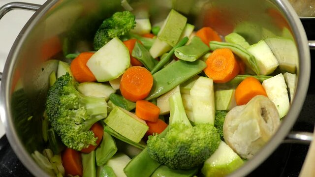 Vegetable selection heating up in a casserole. Concept of healthy food and vegetarian food.